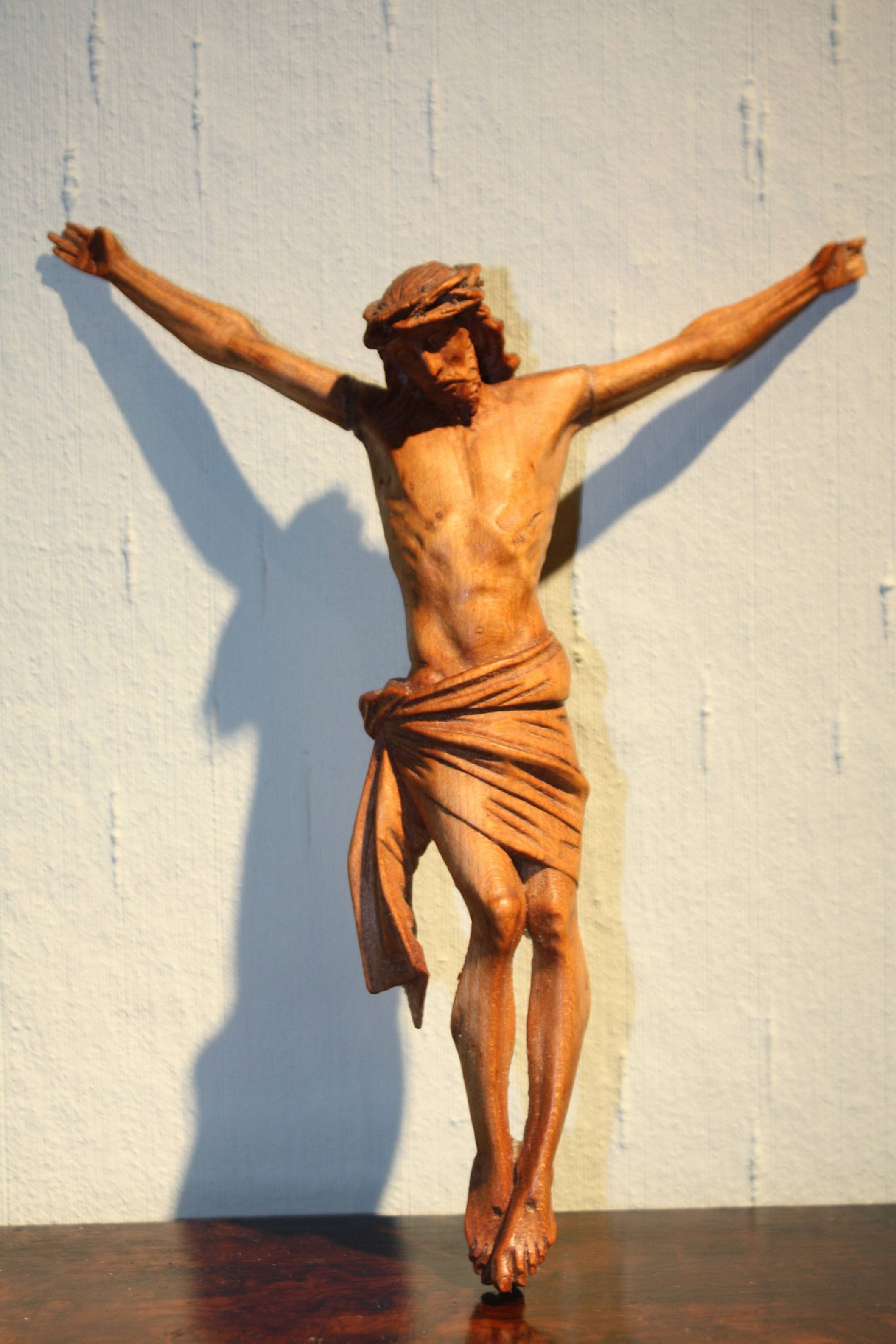 A small antique 19th century hand-carved wooden Jesus Christ figurine