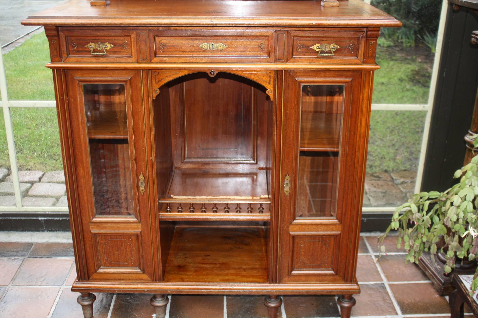A late 19th century walnut show cabinet display cupboard