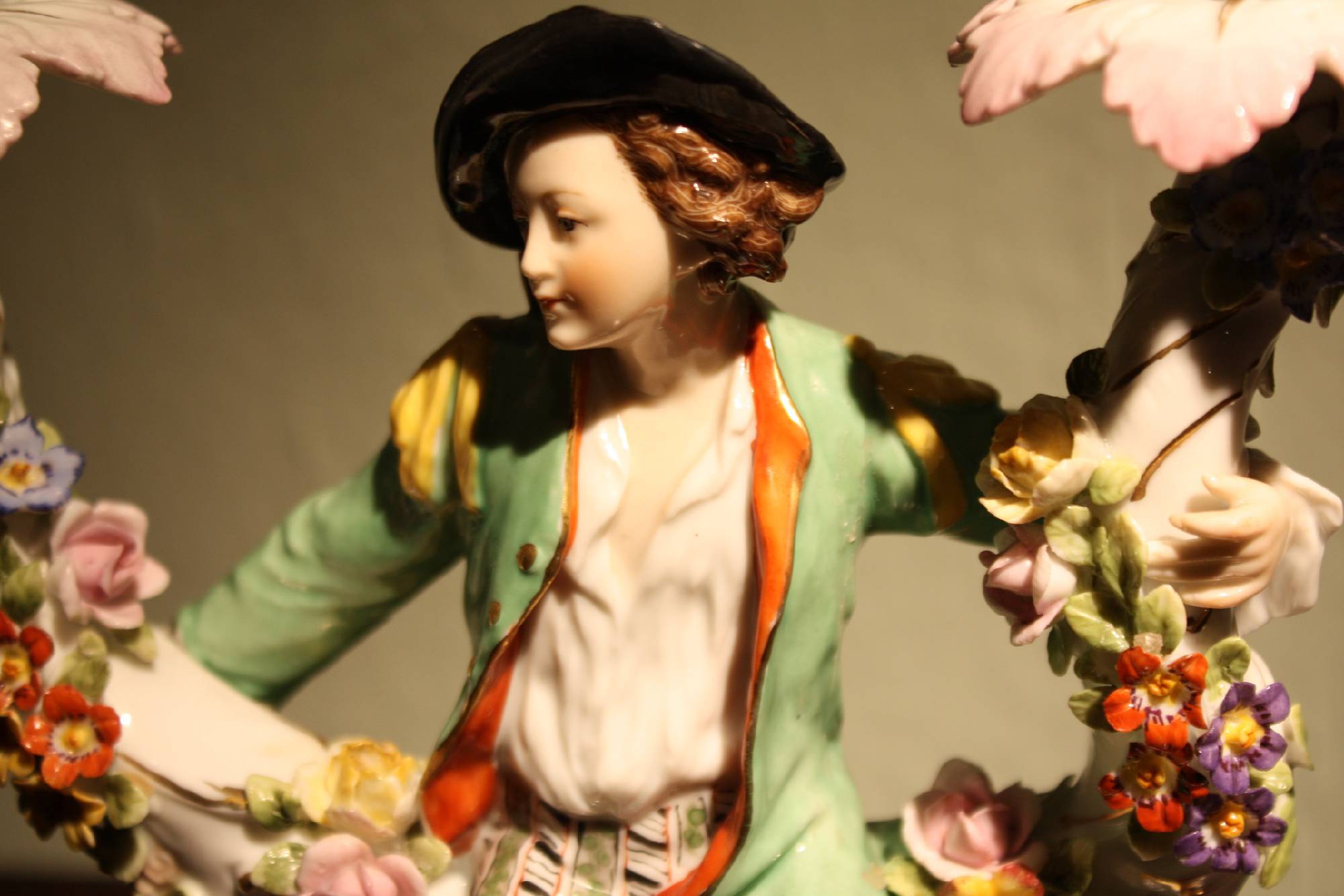 A unique late 18th century German figurative hand painted two-armed porcelain candle holder signed by Hoechst, Germany