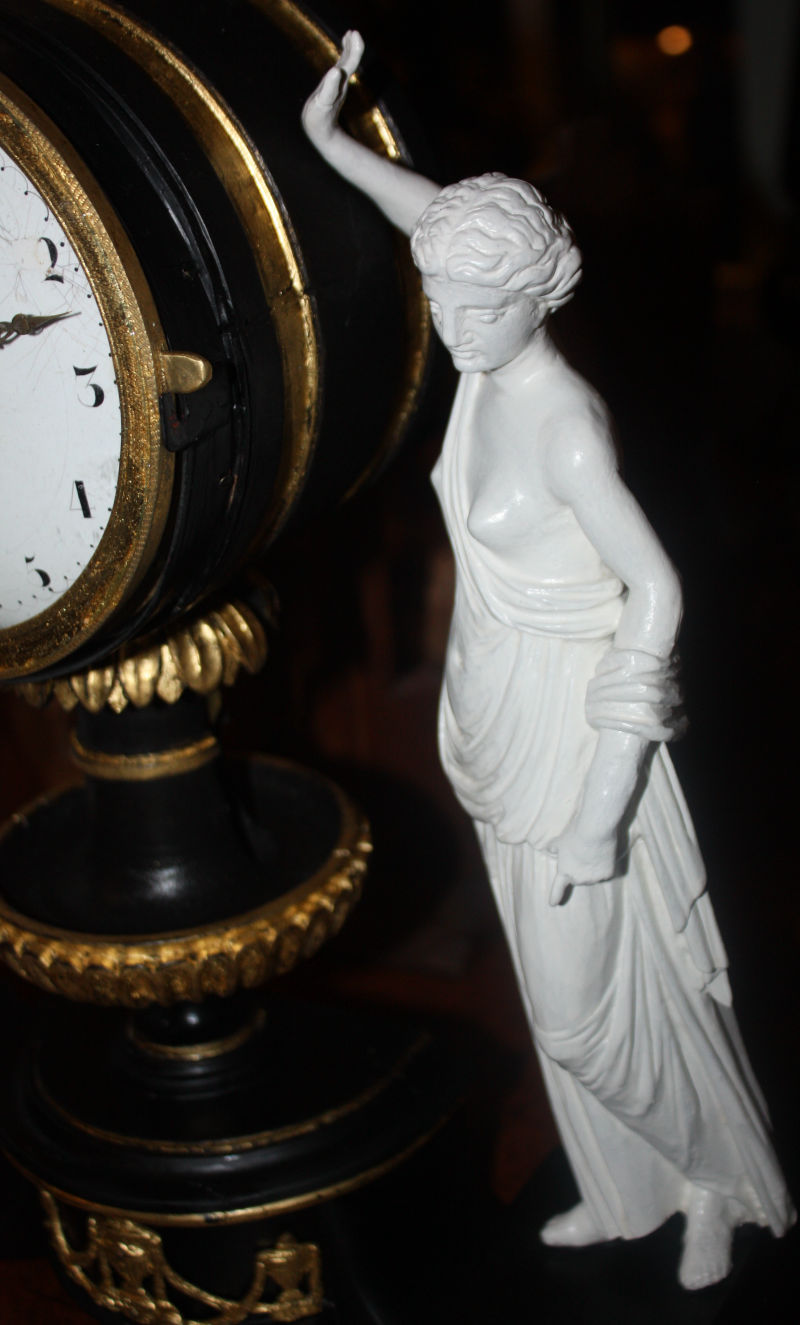 An 1820 Vienna table clock, gilded hand carved lime wood case