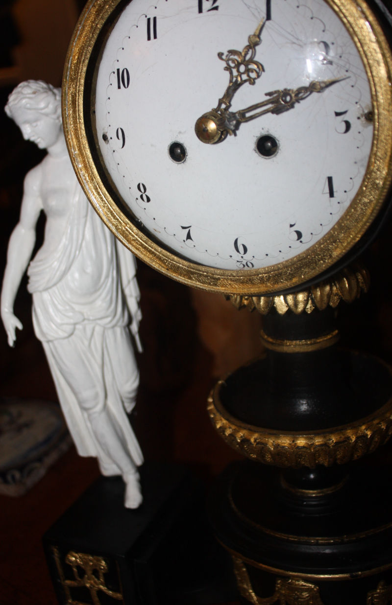An 1820 Vienna table clock, gilded hand carved lime wood case