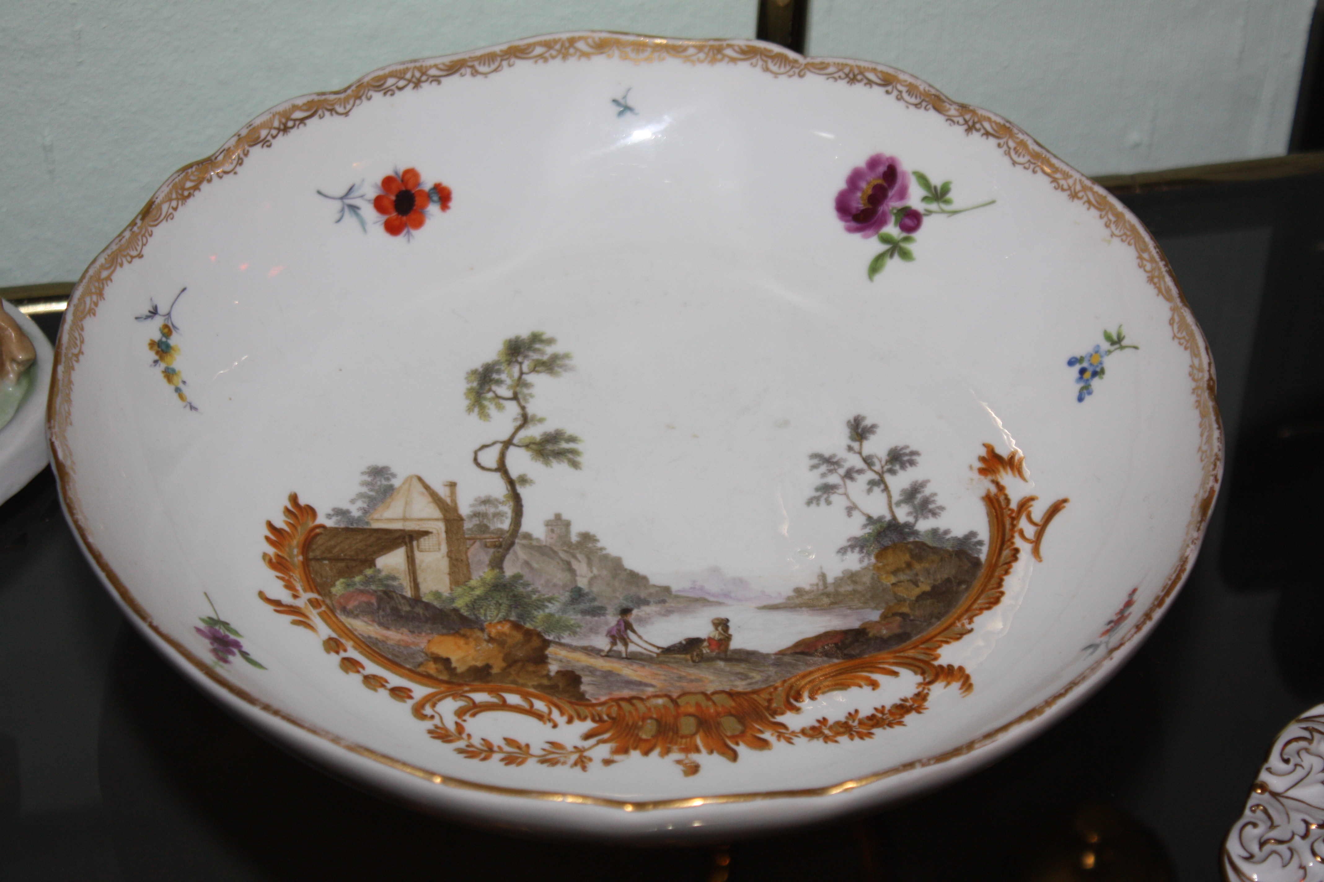 An 18th century Meissen plate with hand-painted romantic scene