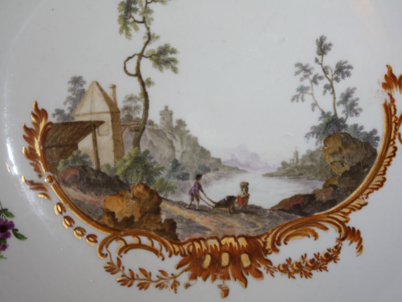 An 18th century Meissen plate with handpainted romantic scene