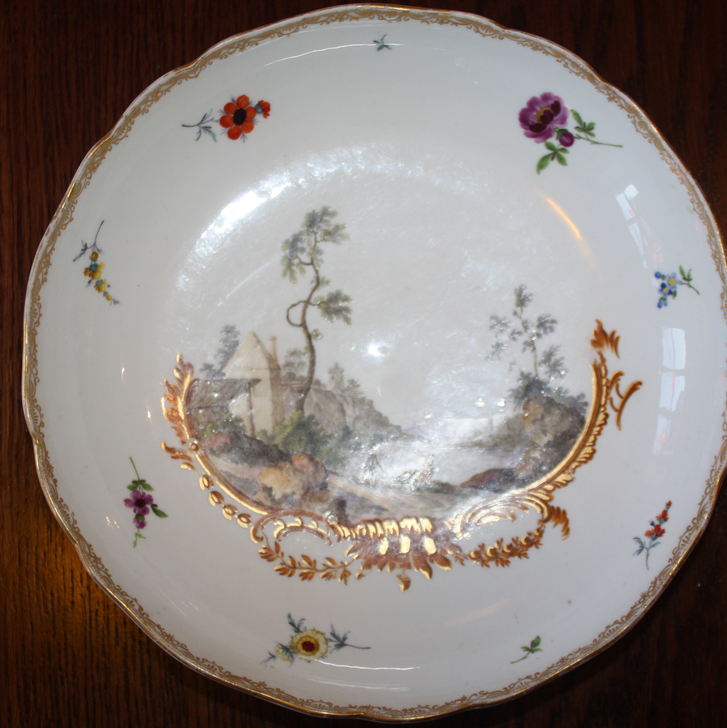 An 18th century Meissen plate with handpainted romantic scene