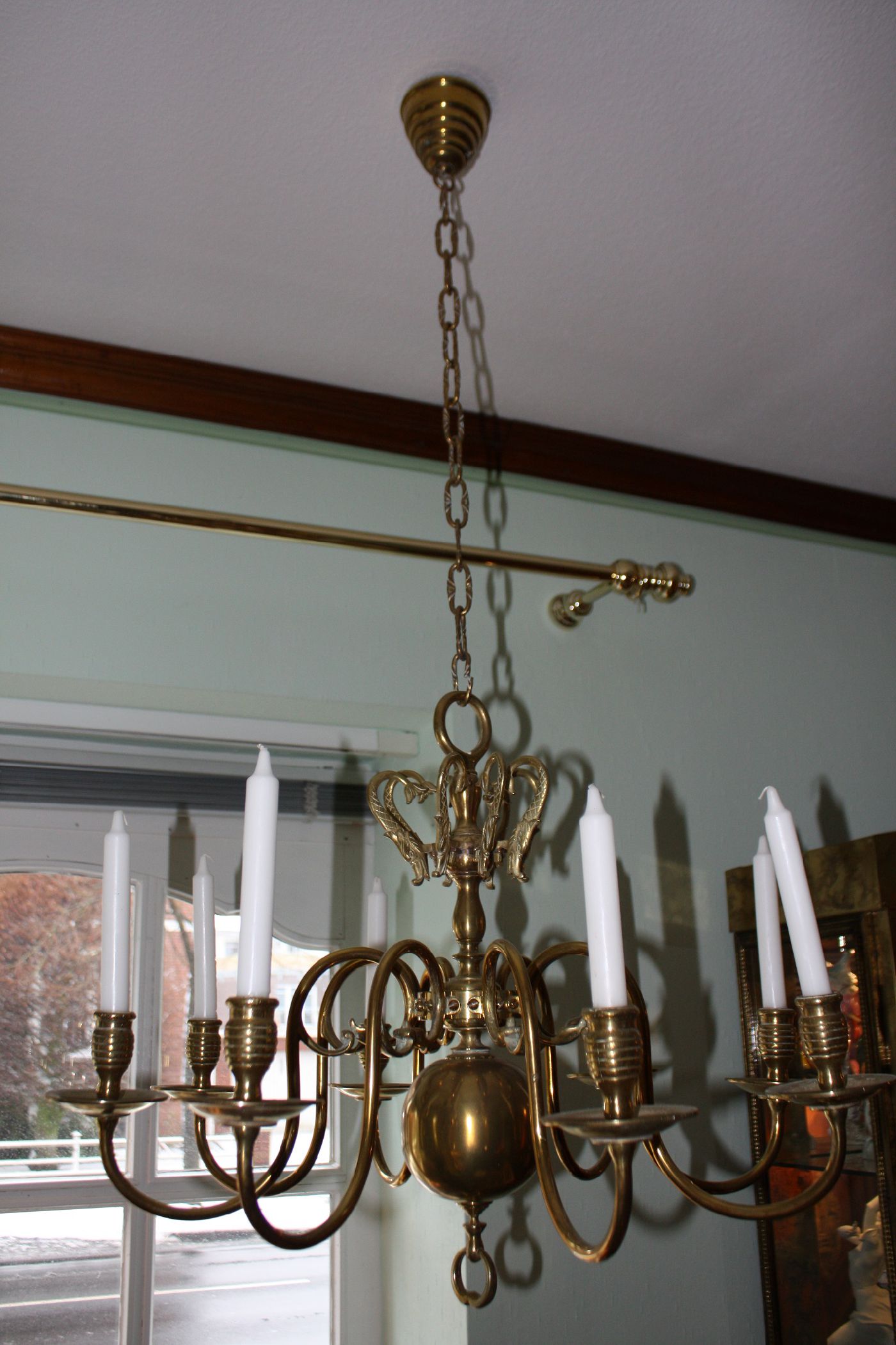 A 19th century flamish or dutch all brass antique chandelier with 8 arms, electrified in the 20th century, in doing so they changed the position of the arms downwards and left the original 8 holders in form of brass fish figurines Size: Diameter: 28.35'' (72 cm)