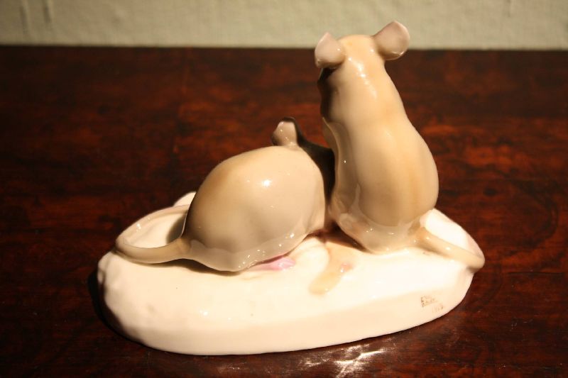 A small rare 1910 hand-painted porcelain figure of two mice eating bacon, signed by Nymphenburg