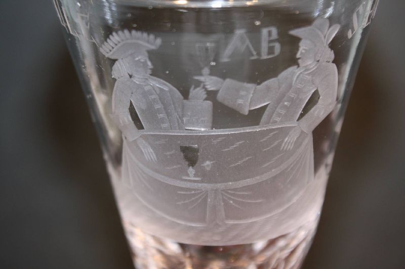 A fine ornate antique 18th century engraved glass motto pokal with scene of two men raising glasses at a table. Motto: 'Vivat Alle Absente Vrinden', means 'Long live all our absent friends'