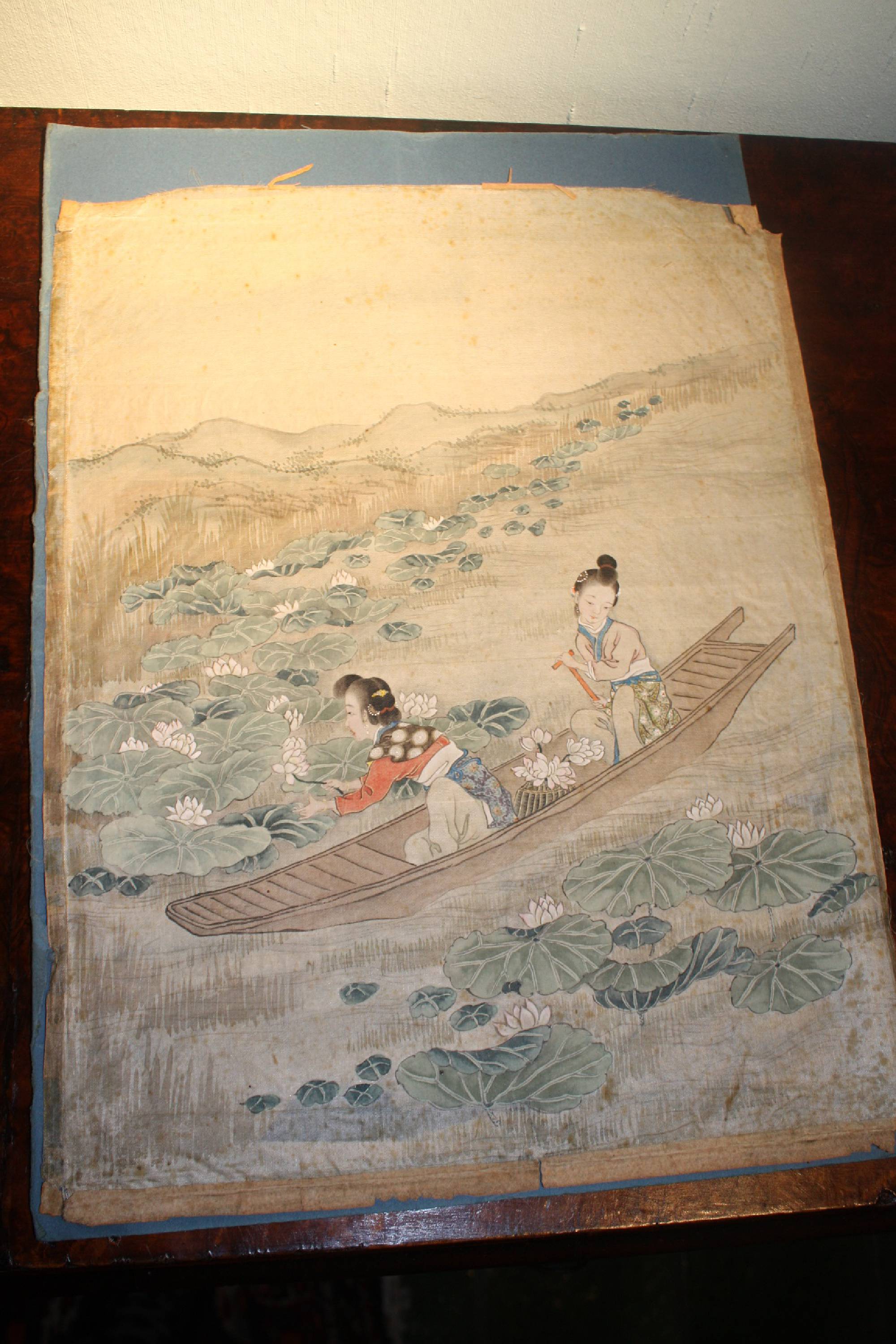 Antique 19th century Asian Japanese silk painting showing two women on a boat collecting lotus flowers
