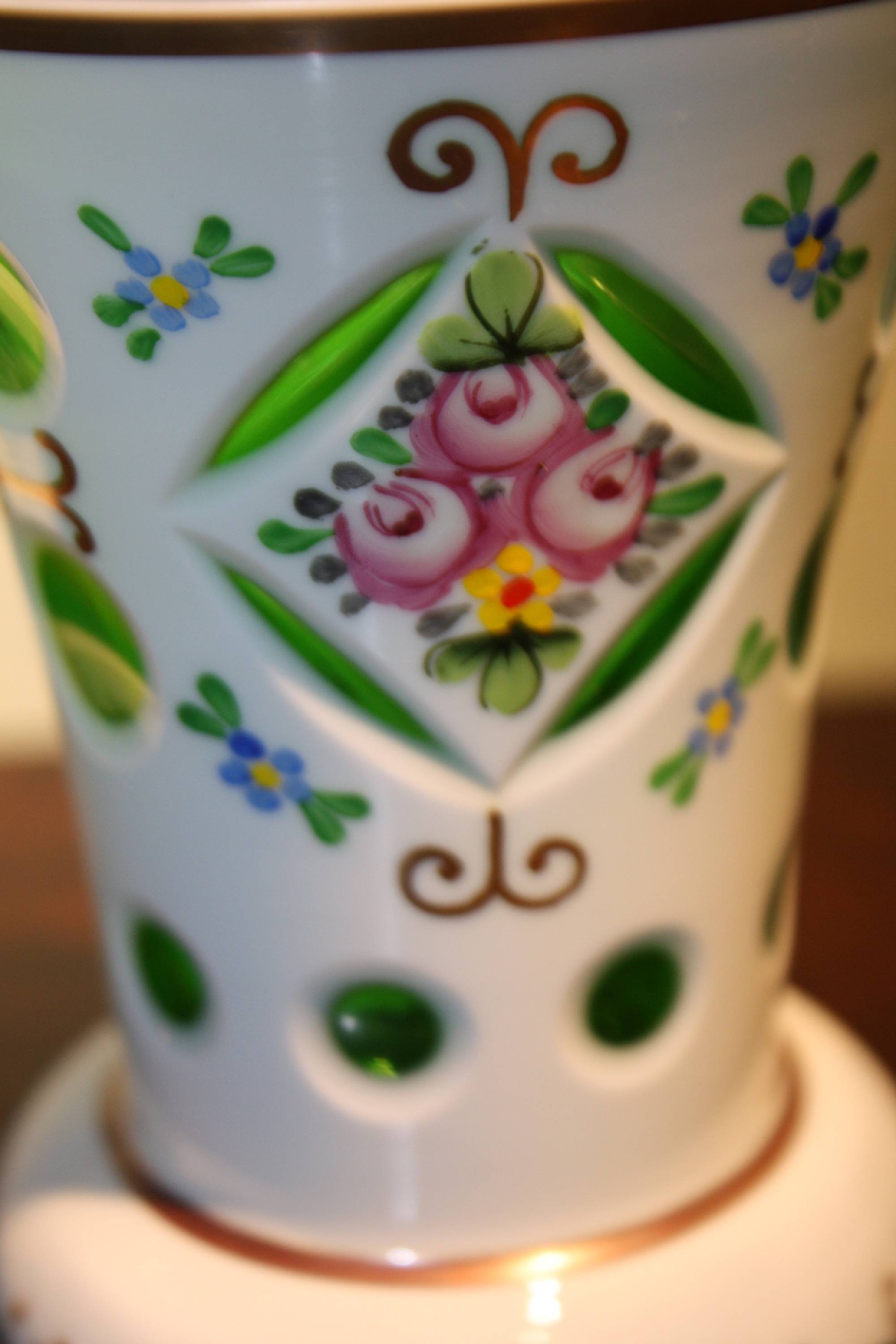 A cute vintage Bohemian 19th century green glass, white milk glass overlay and painted flowers vase
