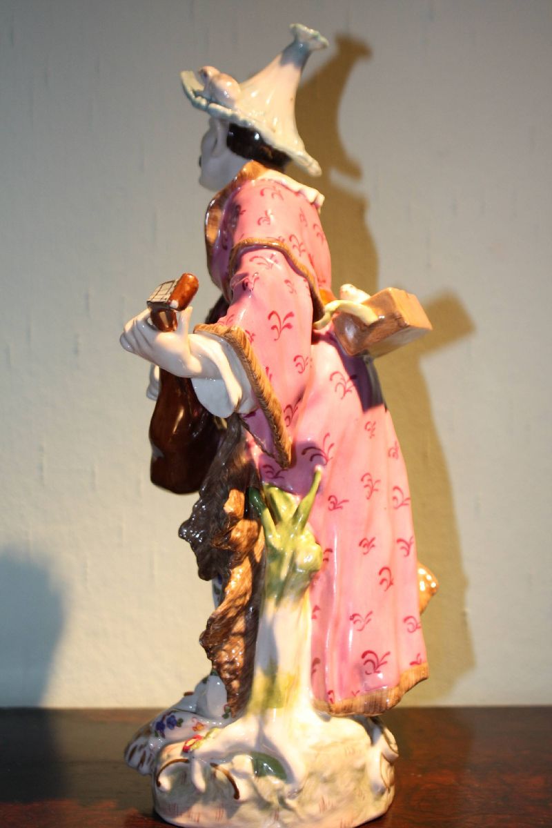 A big antique 19th century handpainted porcelain figure of a musician playing mandolin and singing, by Volkstedt Rudolstadt