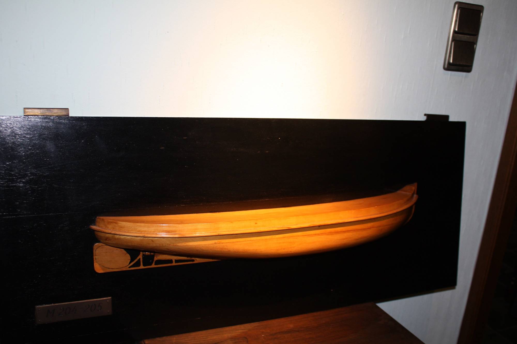 A decorative wooden 1920's/1930's construction related half model of a ship's hull, named 'M204-205'