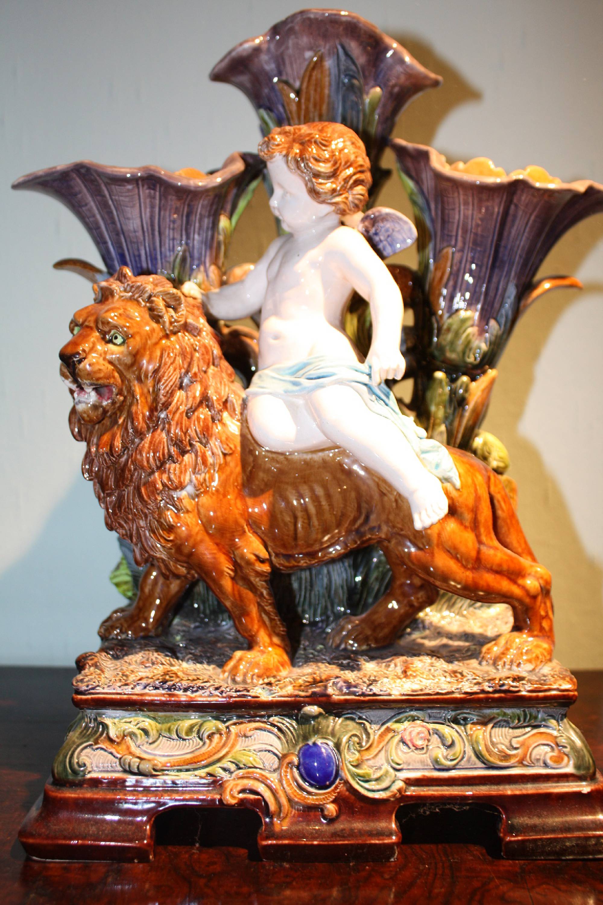 Large splendid 1900 antique majolica, putto riding a lion, behind three calyxes serving as vases