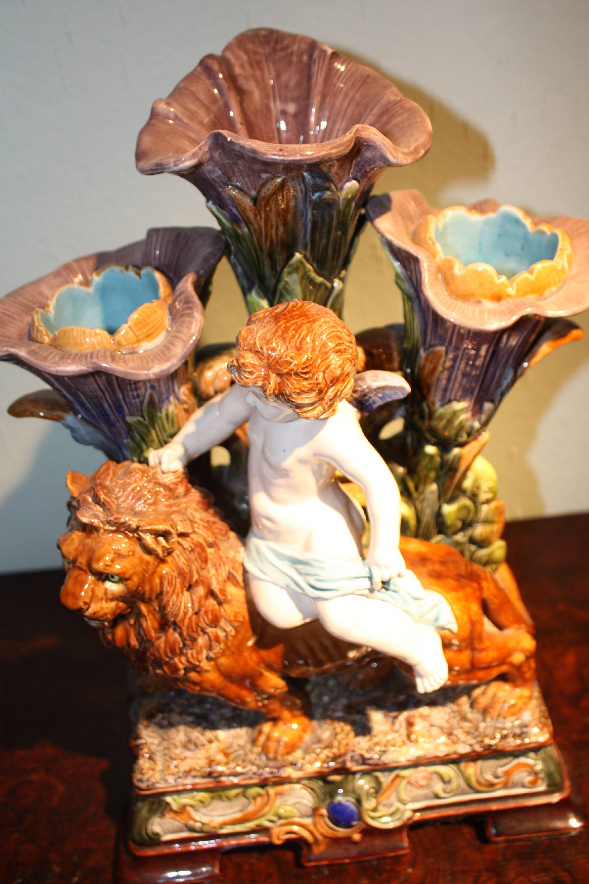 Large splendid 1900 antique majolica, putto riding a lion, behind three calyxes serving as vases