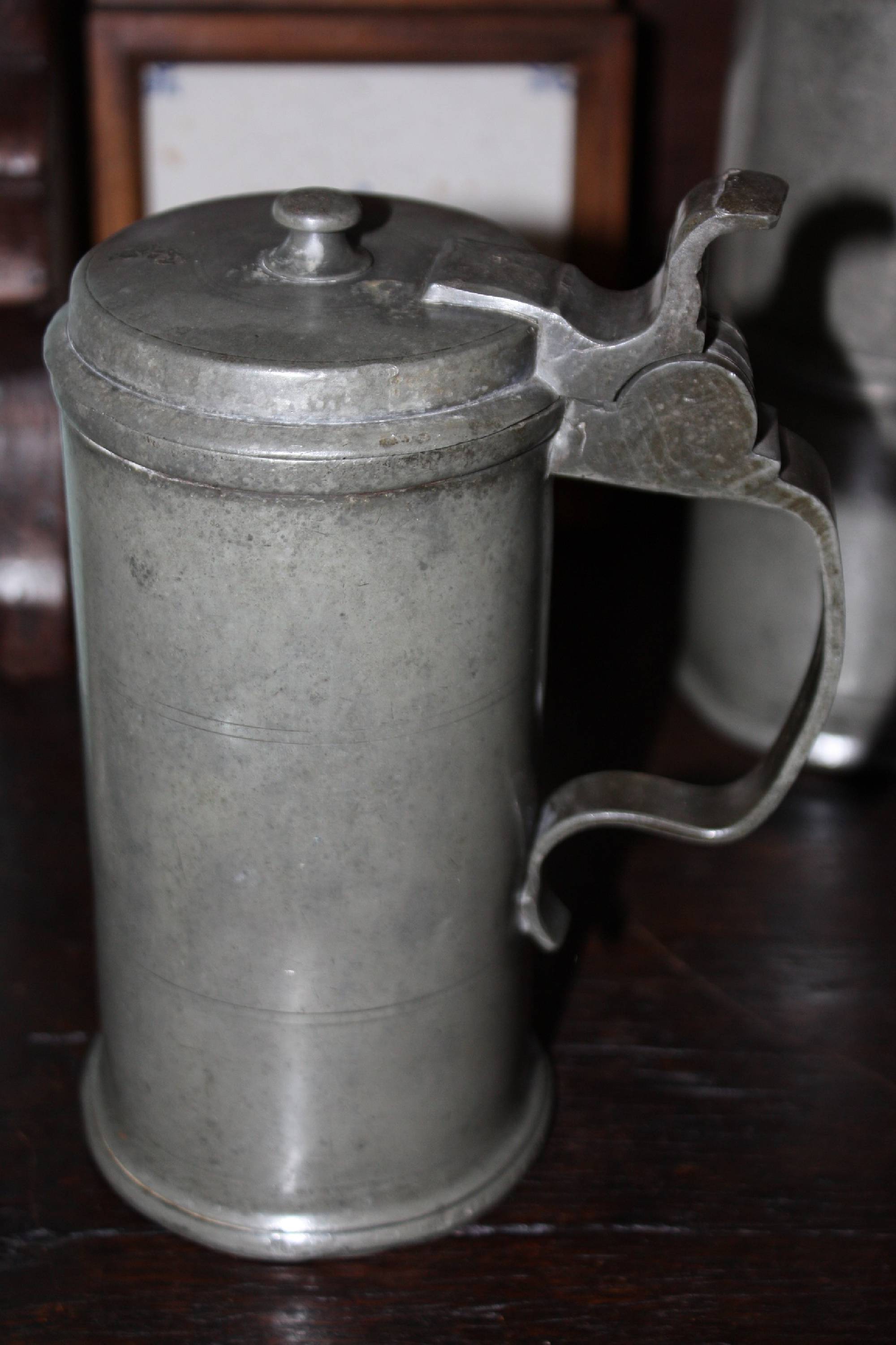 Several antique German pewter items. A hot-water bottle, a brandy bowl and a beer jug, all items signed 'Johann Meinjohann' 